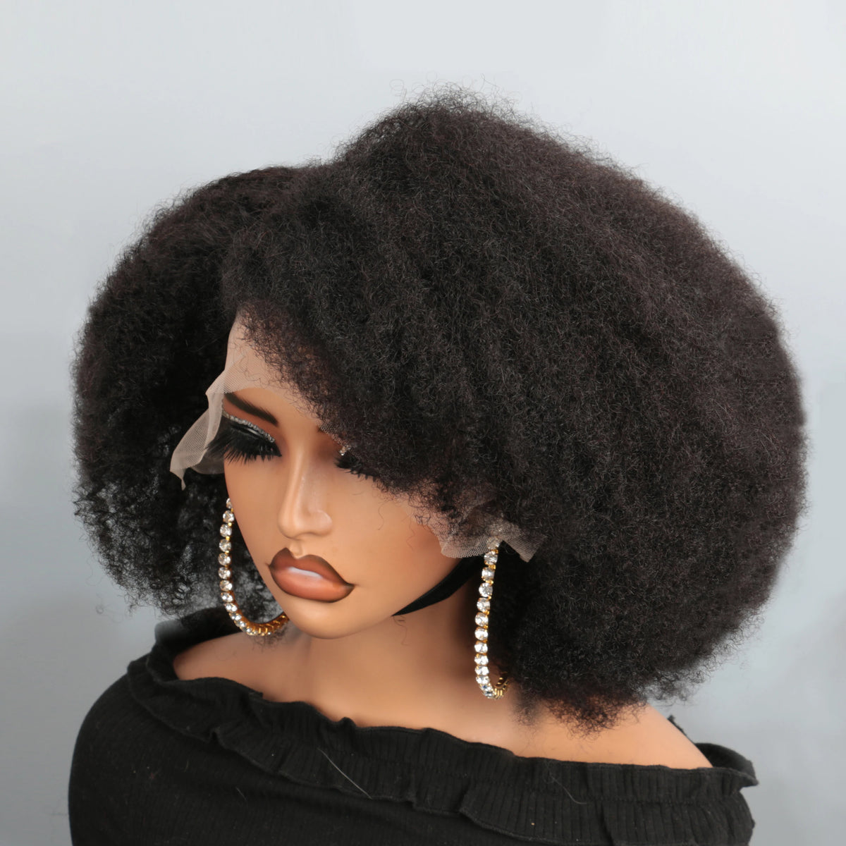 Short black kinky curly human hair lace front wig on a mannequin with a natural hairline.