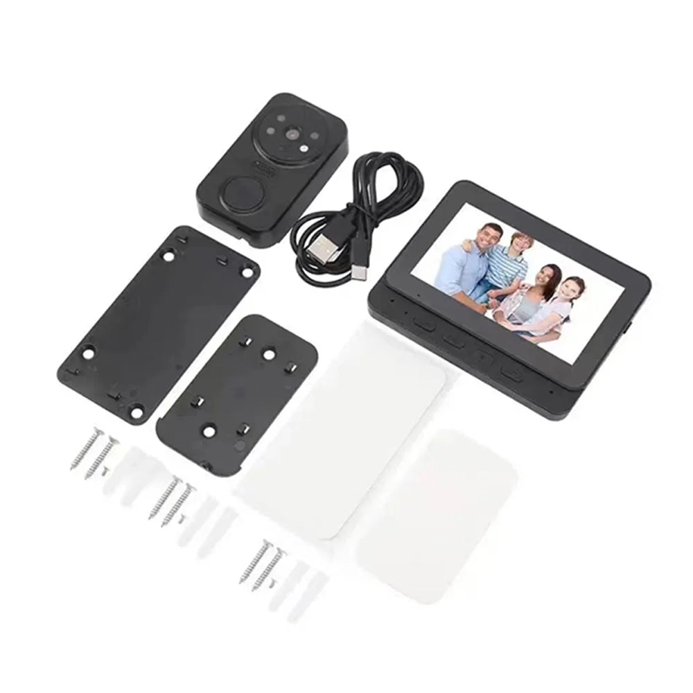 Black wireless video doorbell camera kit with indoor monitor screen, charging cable, mounting plates and screws.