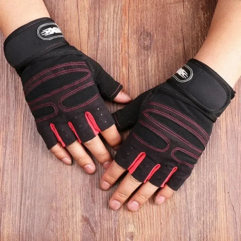 Black and red fingerless gym gloves with adjustable wrist wraps on a wooden background.