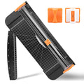 Black and orange paper trimmer with a measurement grid, swing-out ruler, and detachable safety cutting blade.