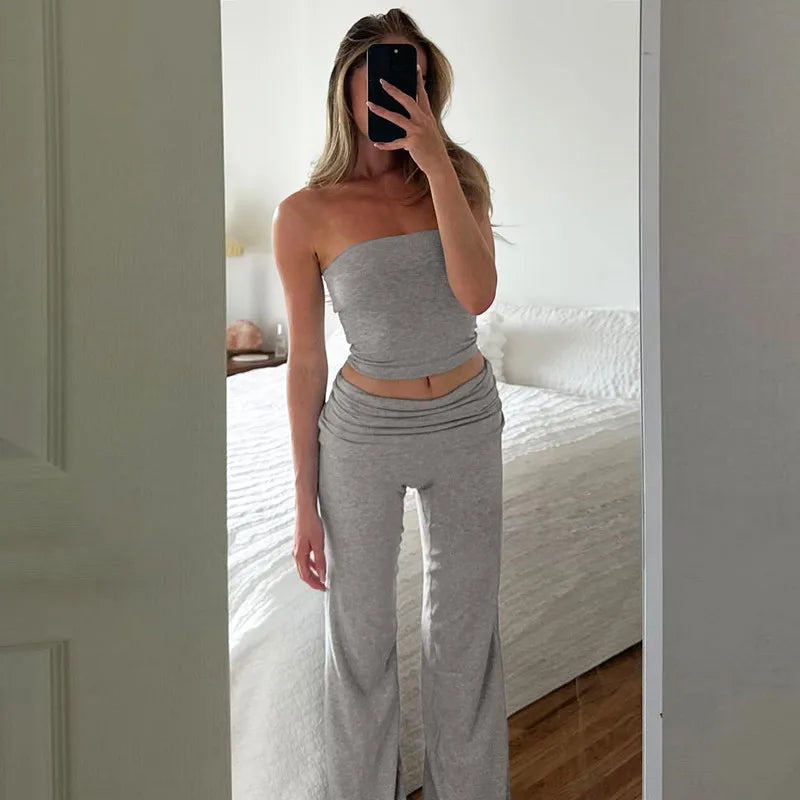 Grey two-piece set featuring a cropped bandeau top and matching wide-leg trousers with a fold-over waistband.
