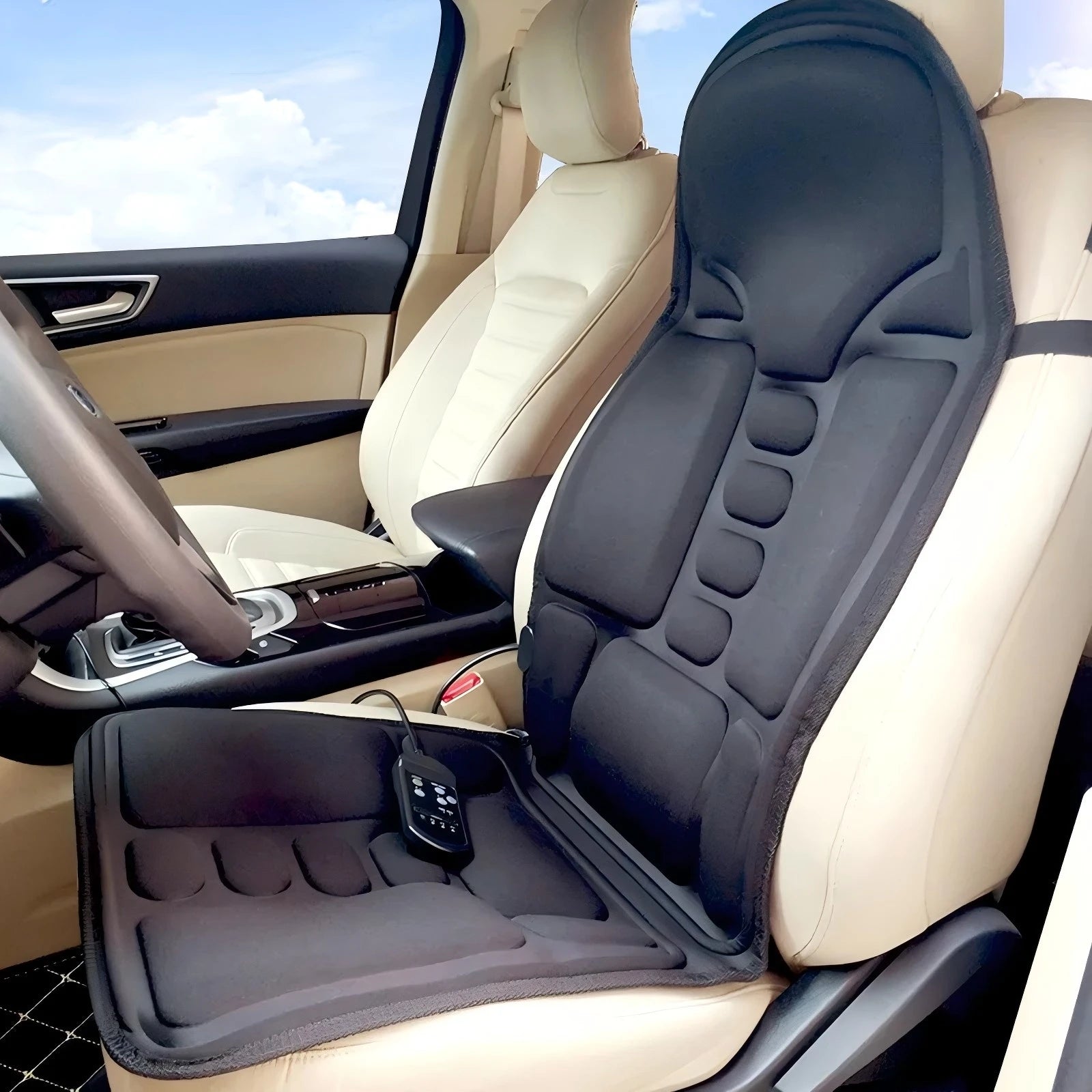 Black, padded heated massage cushion with a handheld controller, fitted to a car seat for comfortable travel.