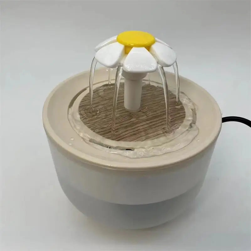Beige pet water fountain with a daisy-shaped topper, wood-look base, and gentle flowing water.