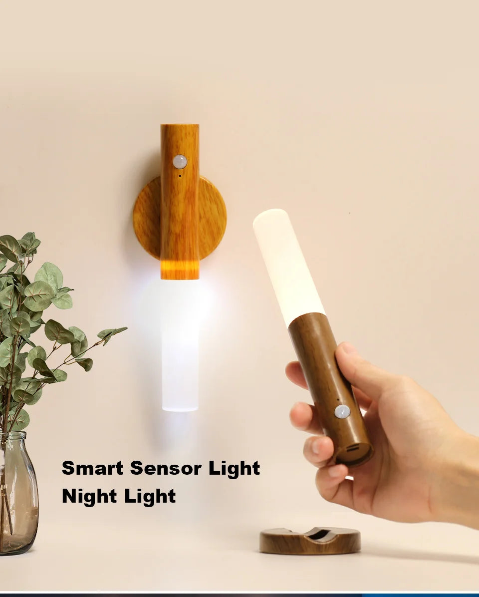 A portable, wooden-style LED night light with a motion sensor, magnetically mounted to a wall or held in hand.