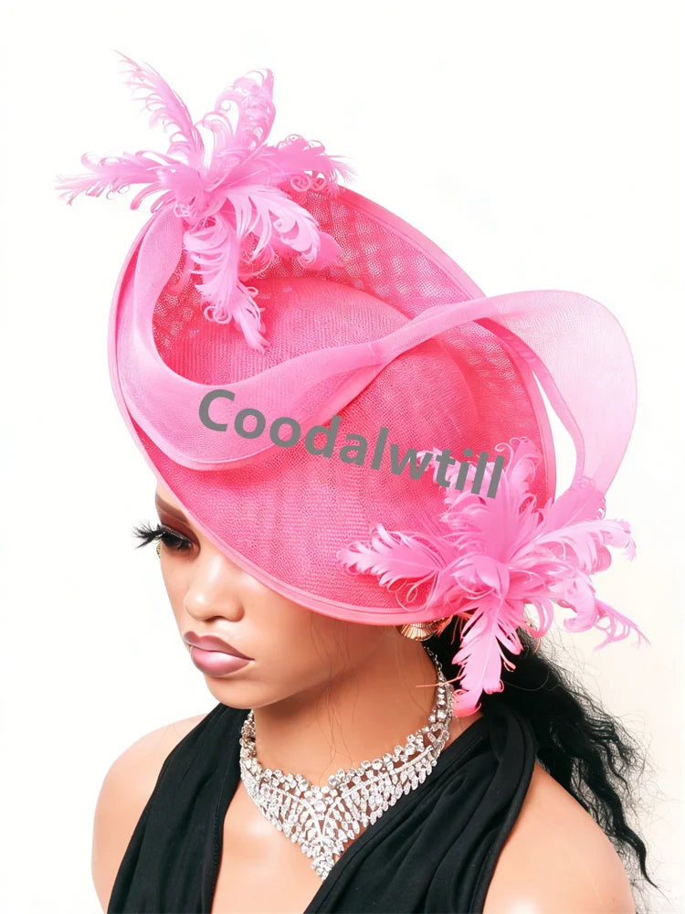 Elegant hot pink fascinator featuring structured mesh, sheer ribbon loops and delicate decorative feathers.