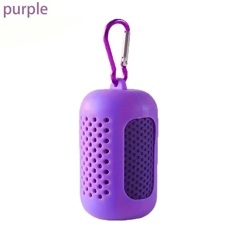A purple, perforated silicone storage case for a cooling towel, featuring a matching carabiner clip.
