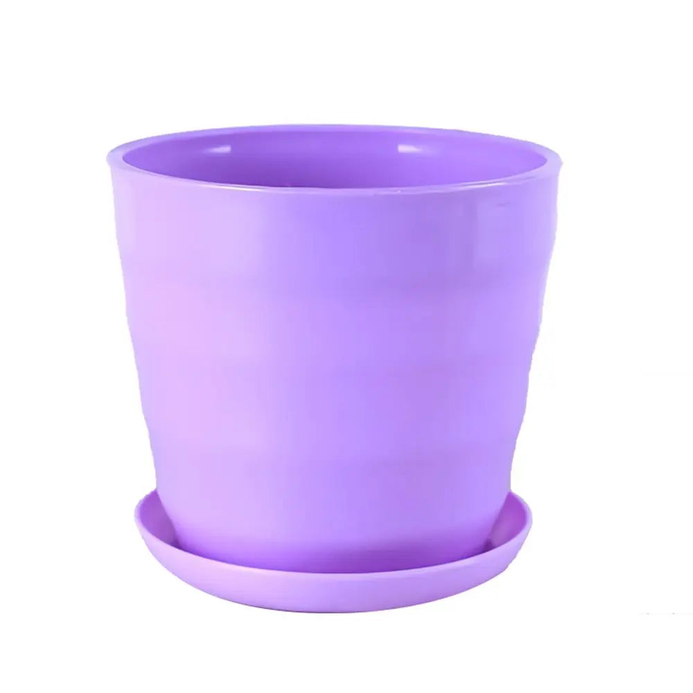 Light purple plastic flower pot with a matching saucer, featuring a decorative ribbed texture on a white background.