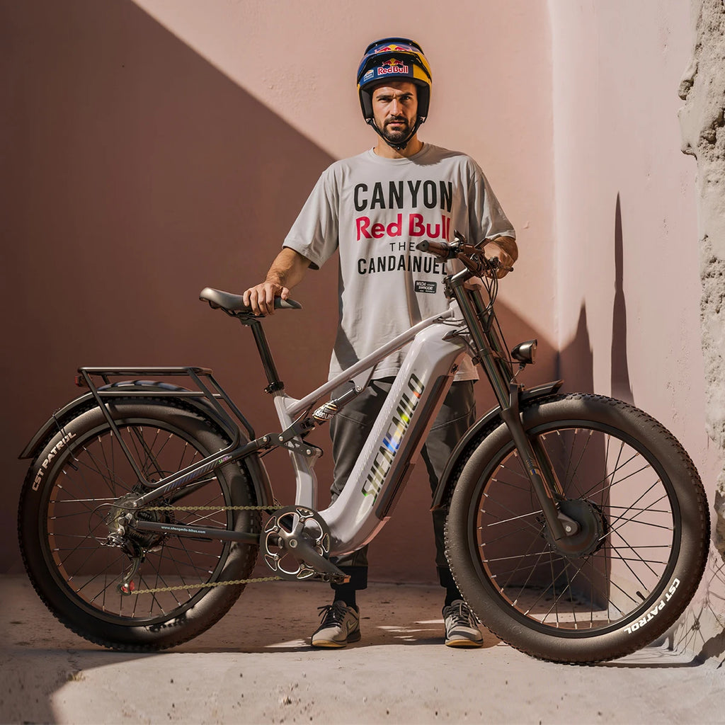 Grey Shengmilo S600 Pro adult electric mountain bike with fat tires and rear cargo rack, shown with a rider.