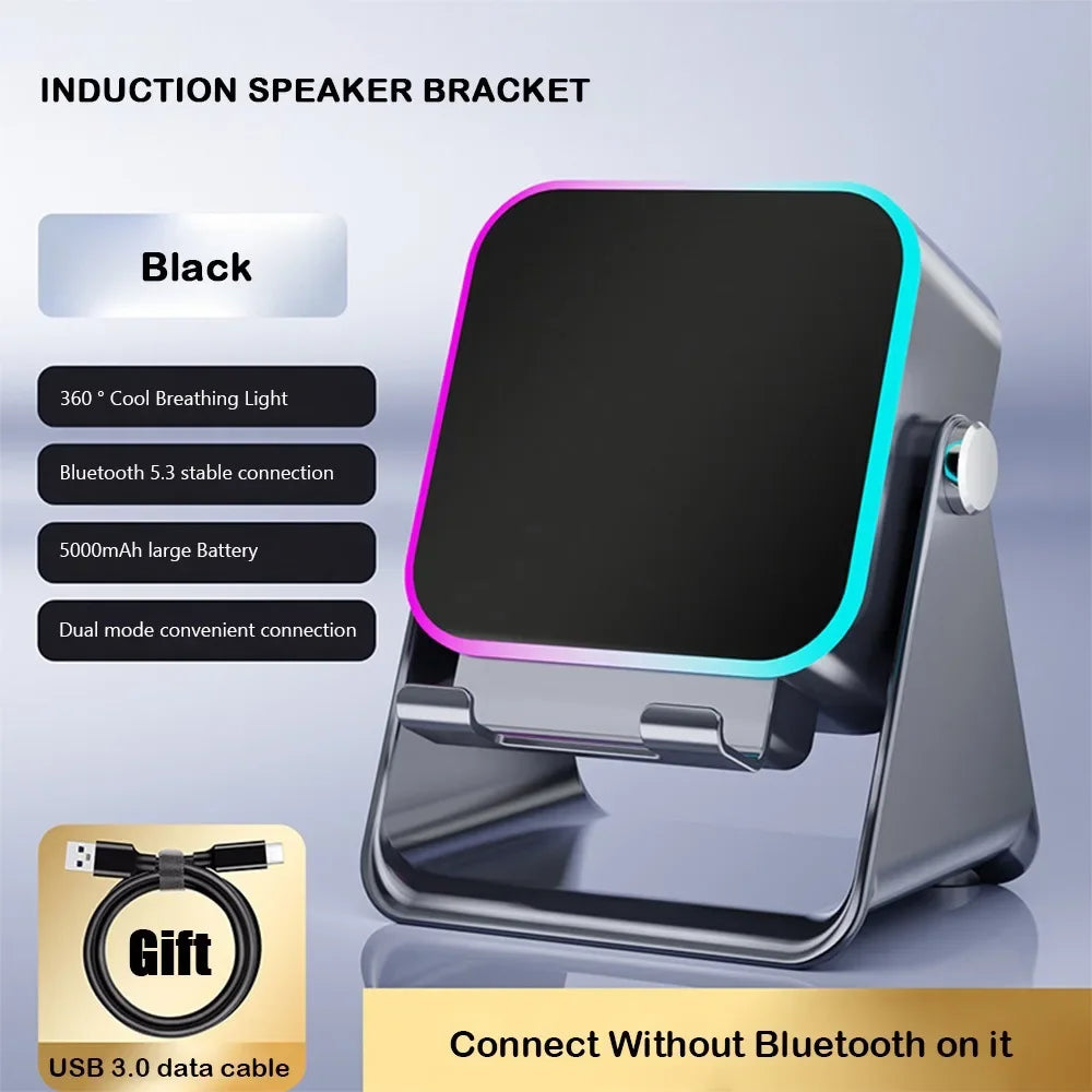 Black rechargeable wireless induction speaker and phone stand with a colourful LED light rim and USB charging cable.