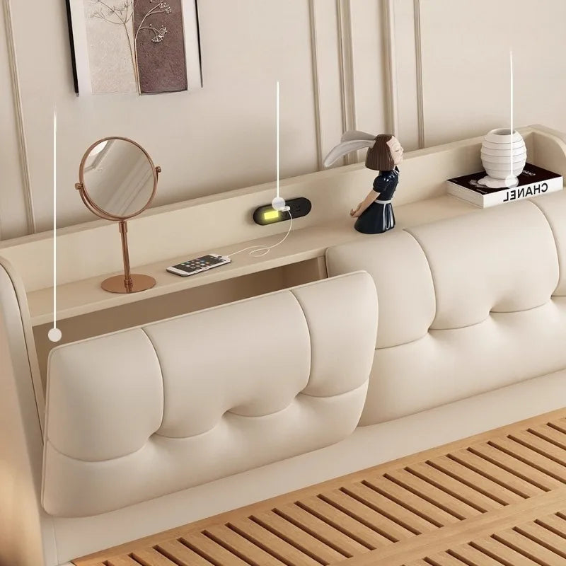 Modern cream leather bed frame with an upholstered headboard, integrated storage shelf and built-in charging ports.