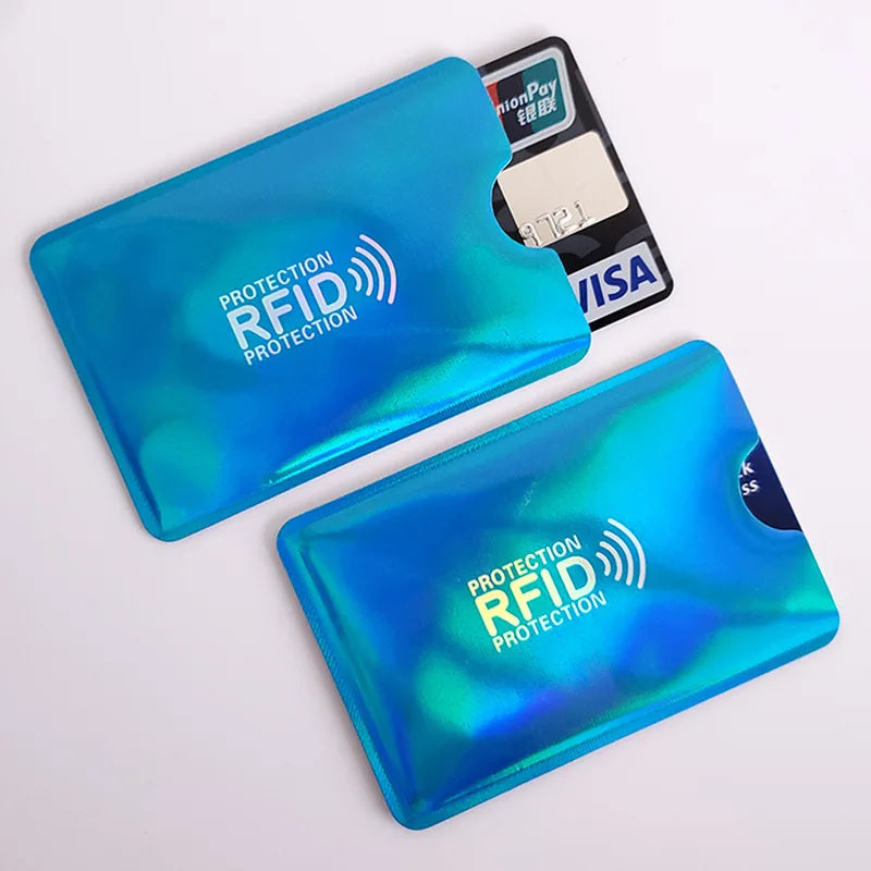 Two shiny blue metallic RFID protection sleeves, one holding a credit card, on a white background.