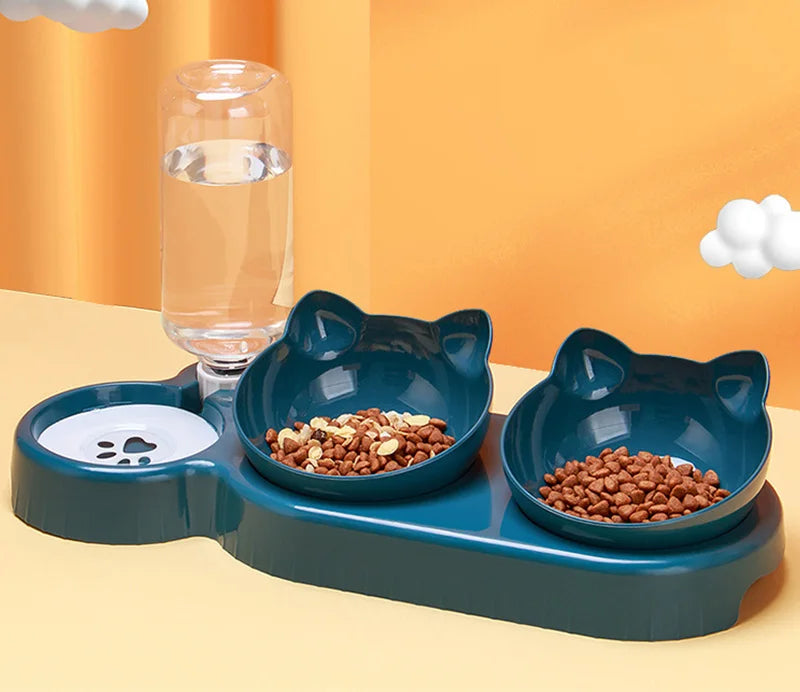 Dark teal, cat-shaped pet feeding station with two food bowls and an integrated water bottle dispenser.