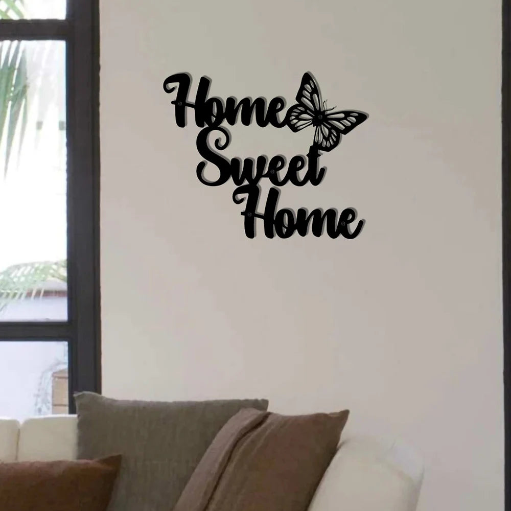 Black metal wall art featuring the text "Home Sweet Home" in cursive script, accented with a delicate butterfly design.