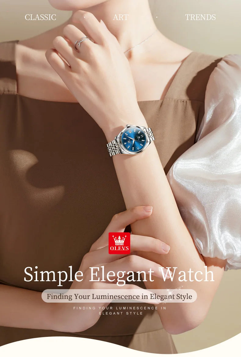 Women's stainless steel watch with a round, deep blue dial, crystal markers and a polished silver link strap.