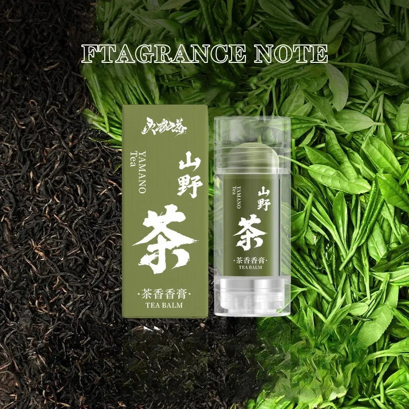 Green Yamano Tea solid balm stick and box on tea leaves background.