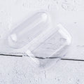 Clear protective case for AirPods, two-piece hard plastic shell on a white wooden background.