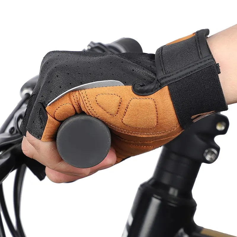 Fingerless cycling gloves in tan and black with padded palms and a secure hook-and-loop wrist strap.