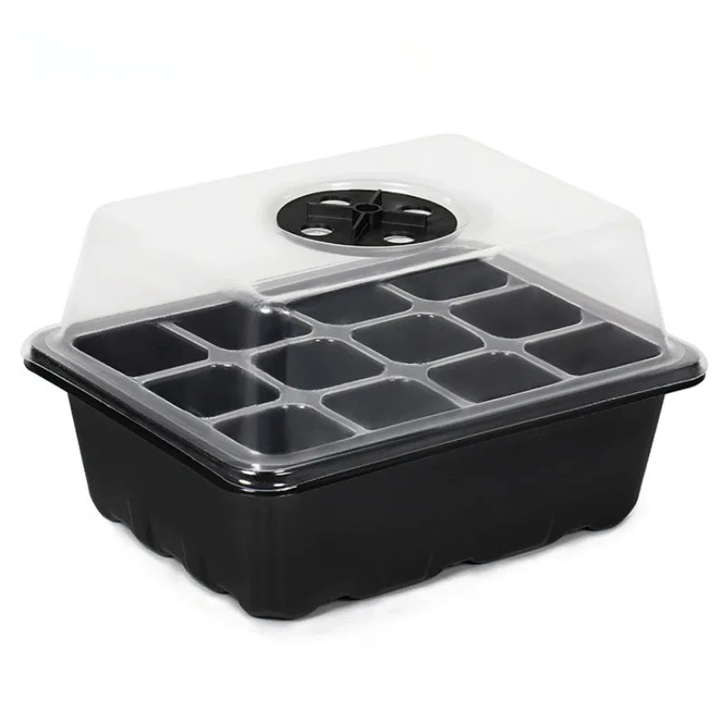 Black 12-cell plastic seedling tray with a clear, vented domed lid for starting seeds on a white background.
