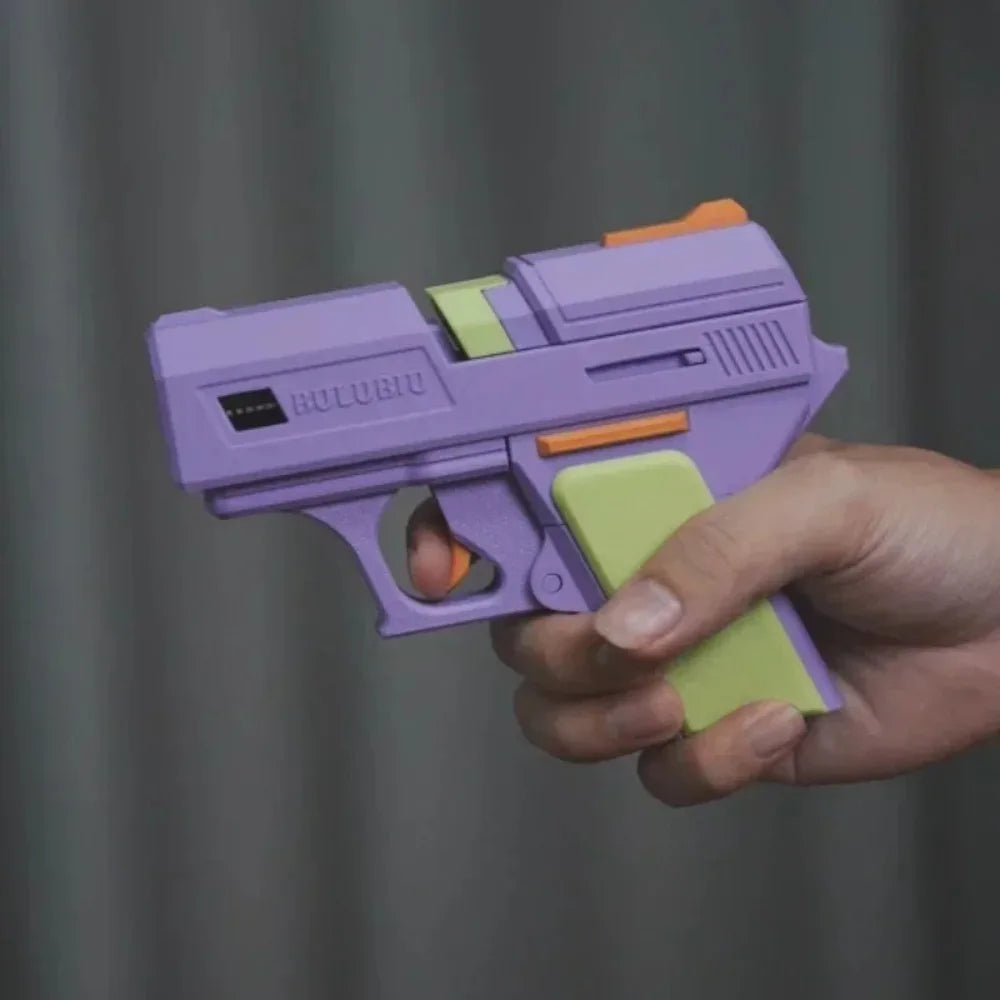 Purple and lime green pistol-shaped silicone case for AirPods, held in hand against a grey background.