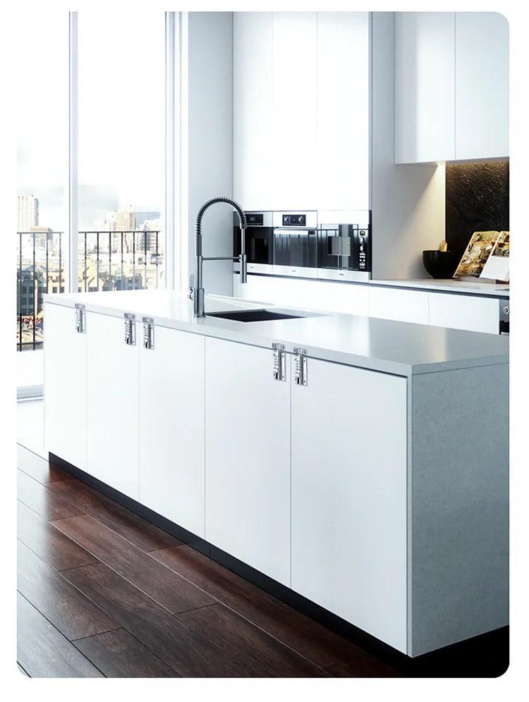White kitchen island with stone countertop, sink, chrome faucet, and exposed industrial-style silver hardware hinges.