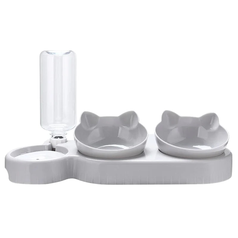 Grey pet feeding station with two cat-shaped bowls and an integrated clear water bottle on a white background.