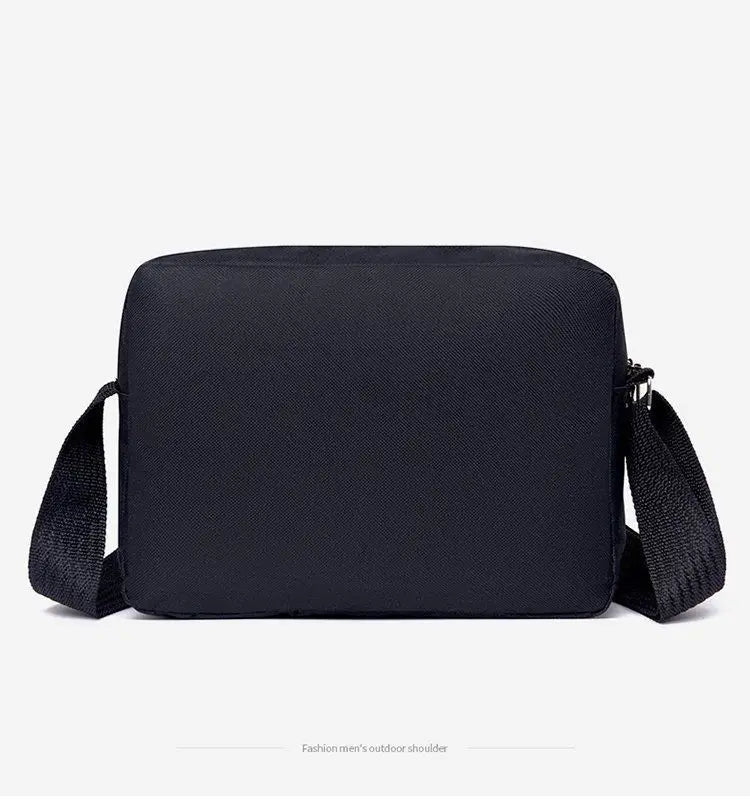 Minimalist black rectangular crossbody bag with an adjustable fabric shoulder strap for travel and business.