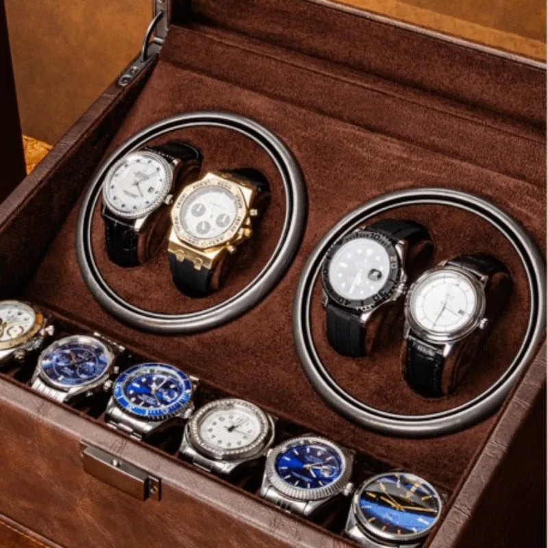 Brown leather mechanical watch winder box holding four automatic watches and six storage slots.