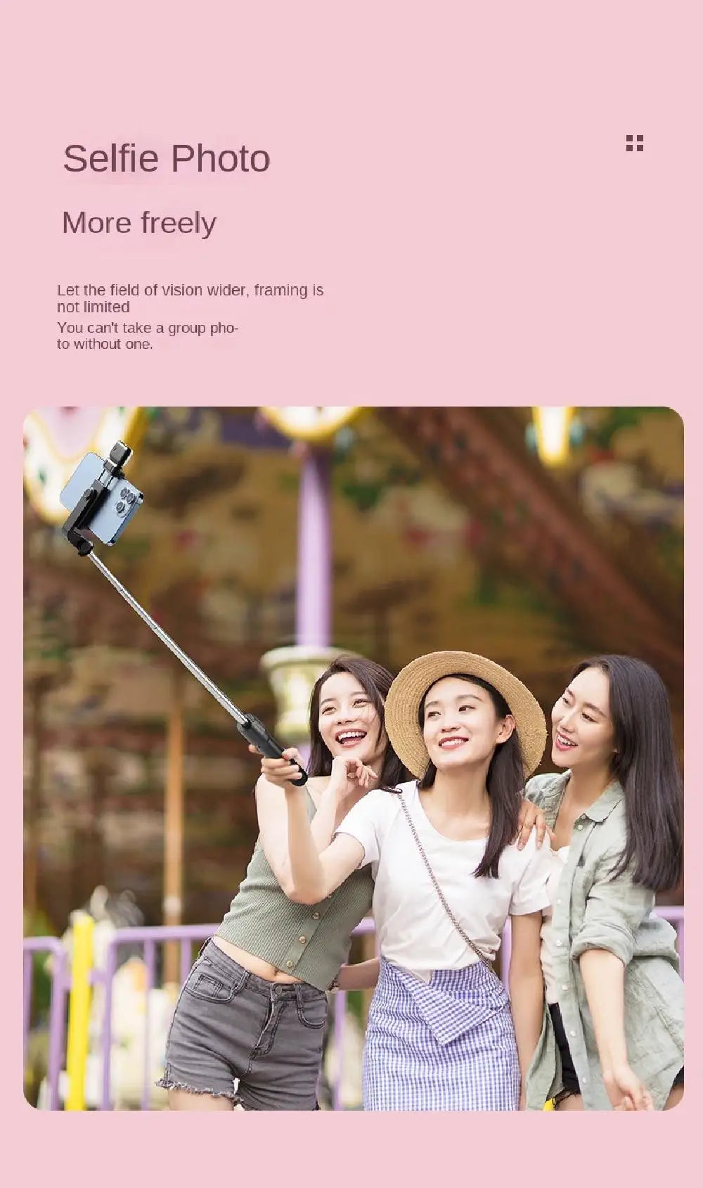 Extendable black selfie stick with smartphone mount being used by three friends for a group photo.