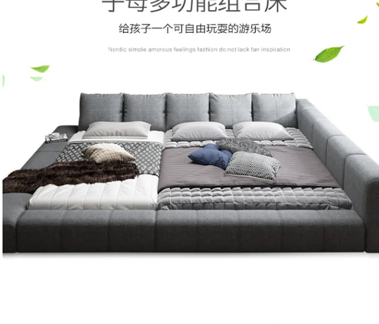 Modern grey fabric double bed with a cushioned, wrap-around headboard and low-profile frame.