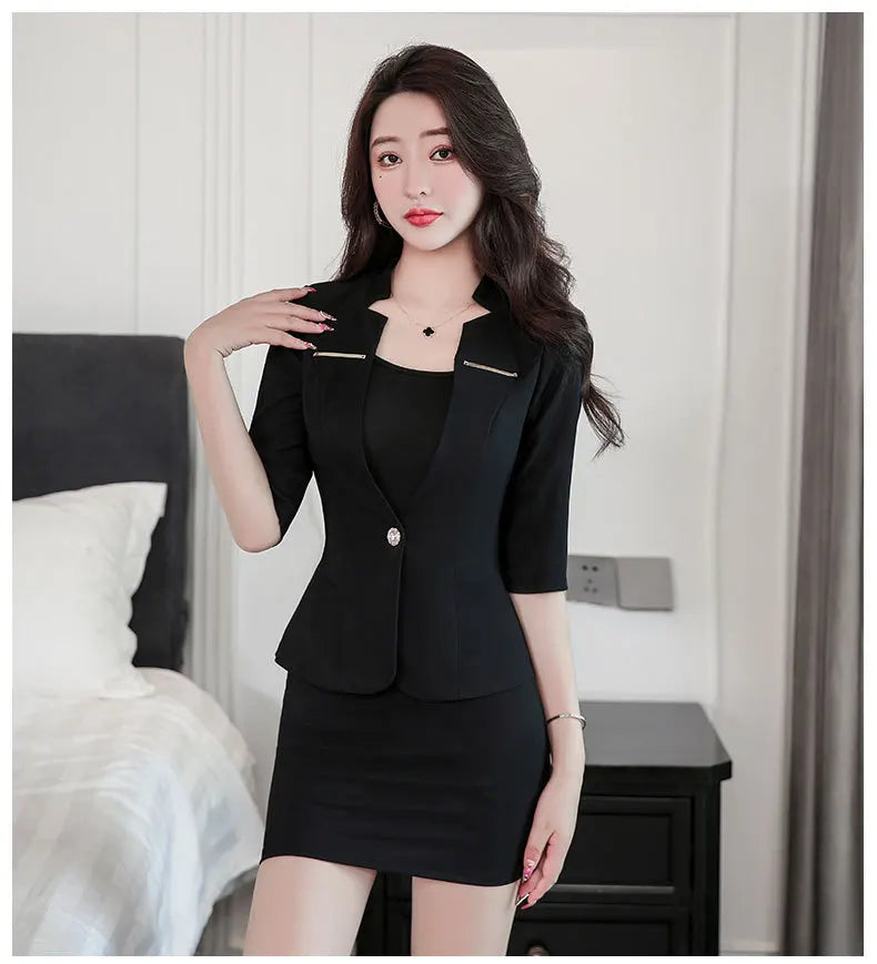 A woman wearing a smart black blazer with three-quarter sleeves and a matching mini skirt, featuring a single-button front.