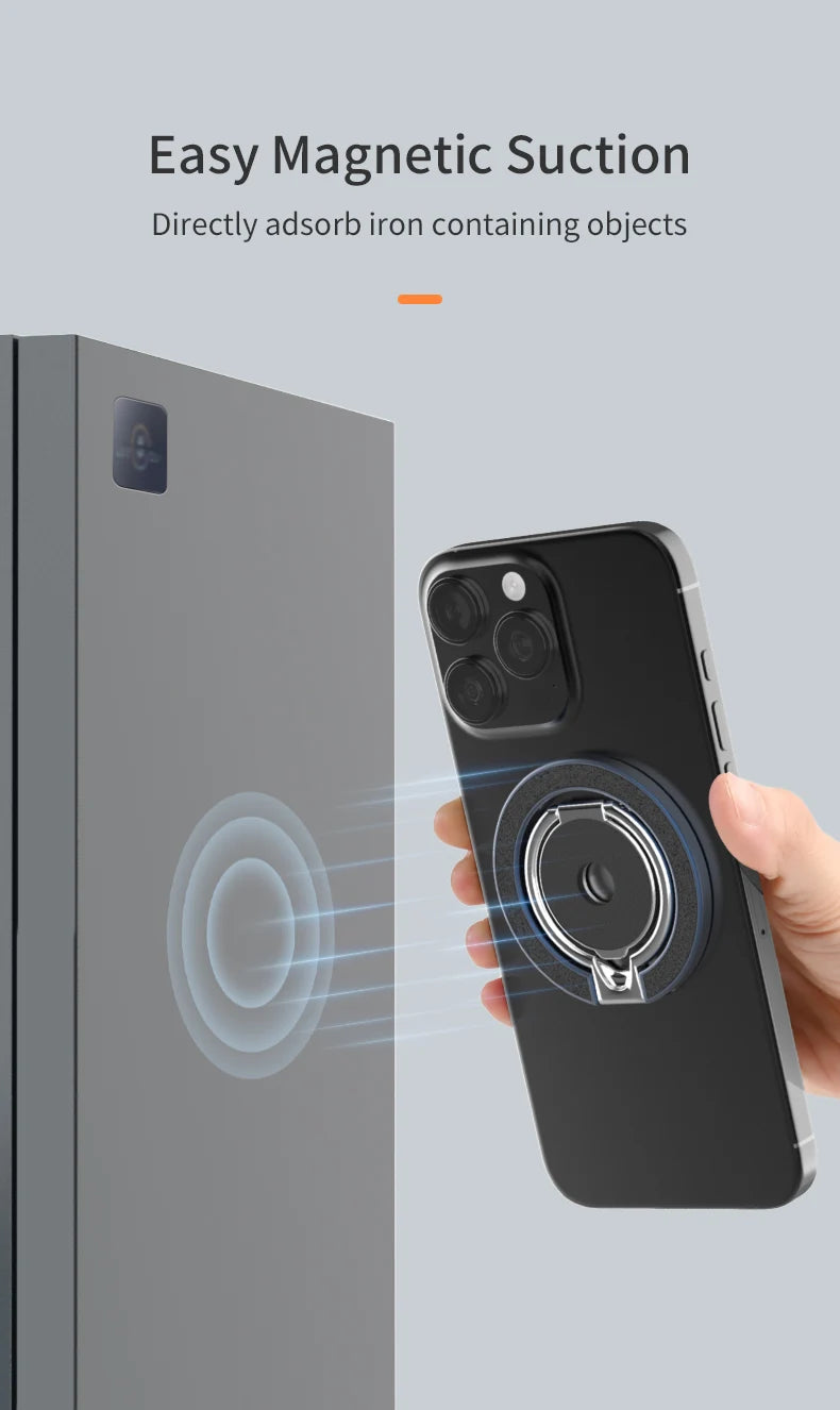 A black phone with a circular silver magnetic ring holder attached to the back, magnetically attracting to a gray surface.