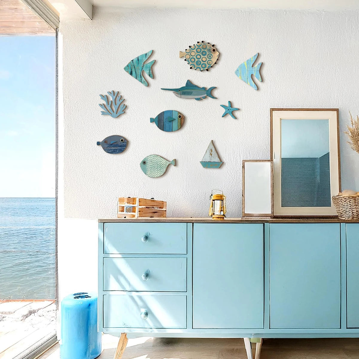 Handcrafted wooden wall decor set featuring blue coastal-themed fish, a starfish, coral, and boat shapes.