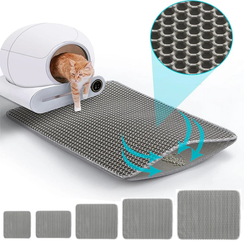 Grey, large waterproof cat litter mat with a honeycomb top layer to trap scatter, shown with a cat and litter tray.