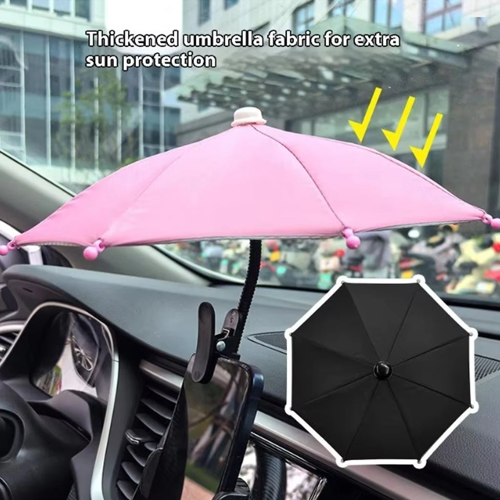 Pink and black mini car phone sunshade umbrellas with flexible clips for glare protection on a vehicle dashboard.