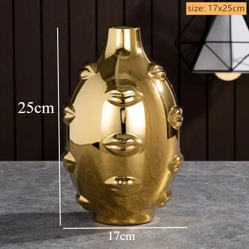 Gold-tone decorative ceramic vase, 25cm tall, featuring raised, abstract lip motifs around the exterior.