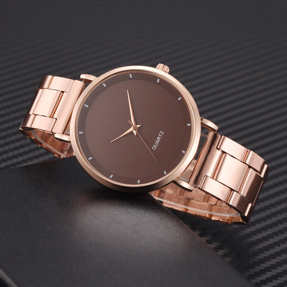 Elegant rose gold stainless steel watch with a minimalist brown circular face and slim metallic hands.