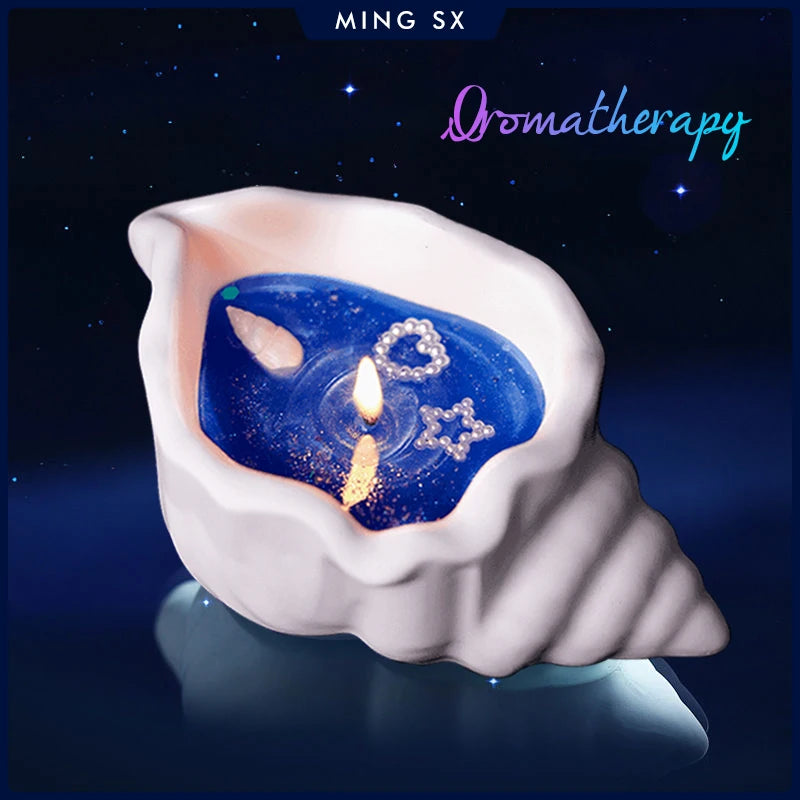 White conch shell candle holder with blue wax, a single flame, and decorative heart and star accents.