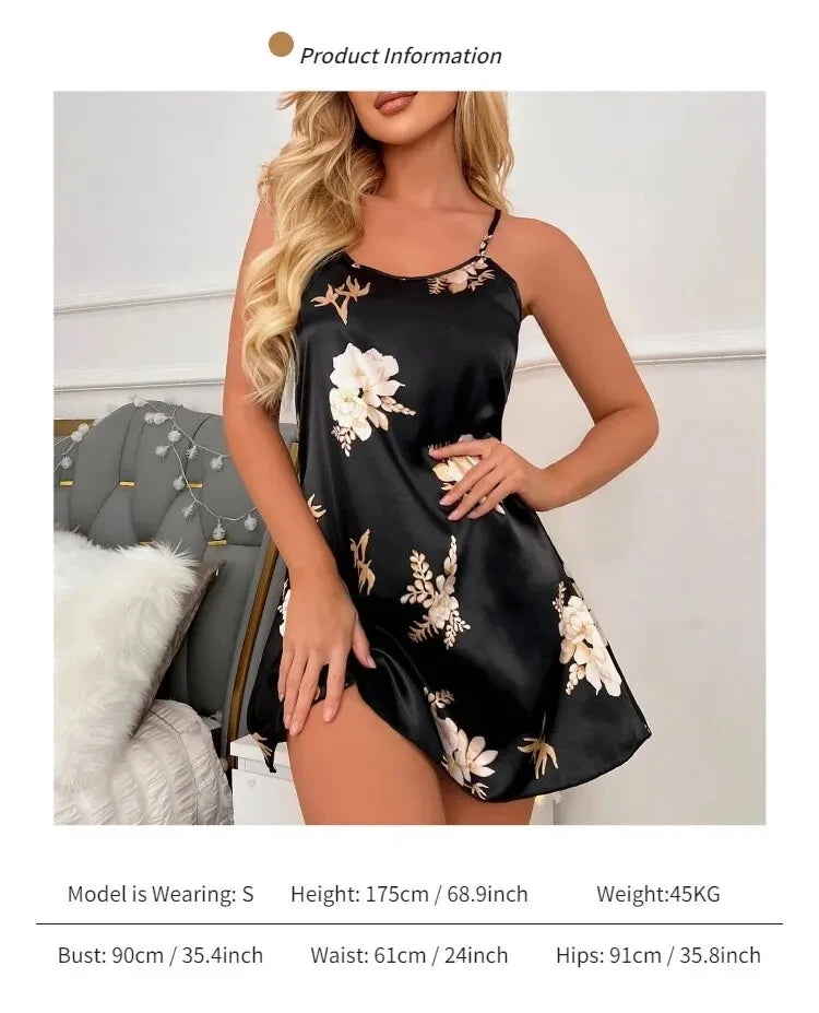 Black satin camisole nightdress with a floral print, thin adjustable straps, and a relaxed, mini-length fit.