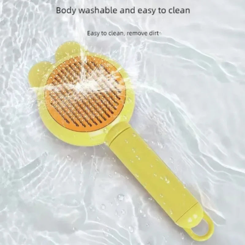 A yellow bear-shaped pet grooming brush being washed in water.