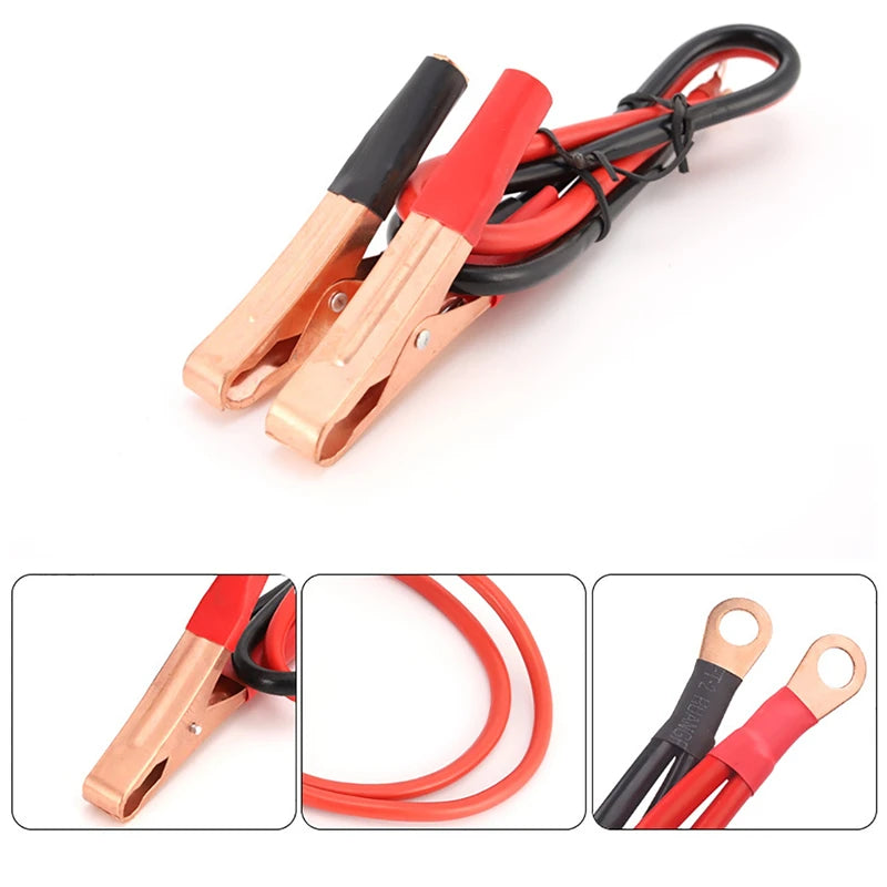 Heavy-duty battery jump leads with copper-tone clamps, red and black rubber handles, and eyelet terminal ends.