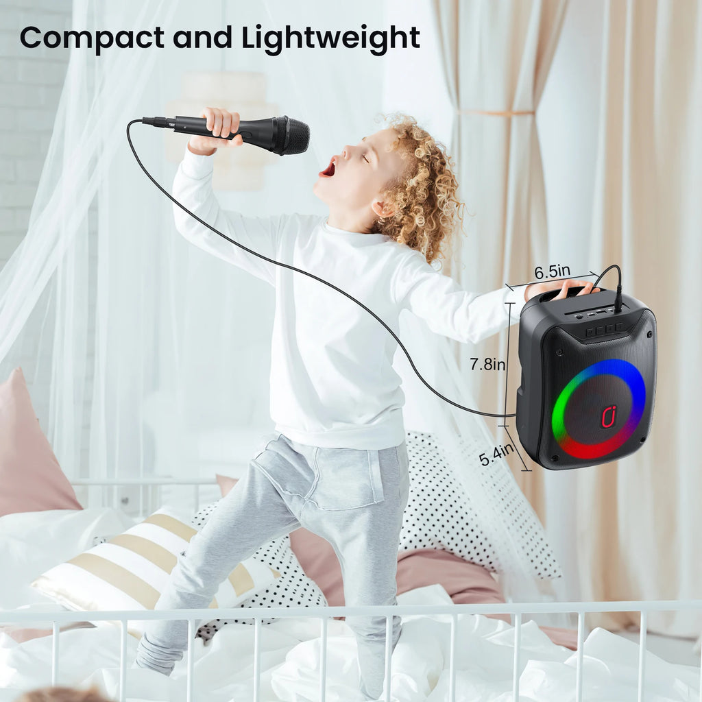 Child singing into a handheld microphone connected to a compact black wireless speaker with colourful LED light rings.