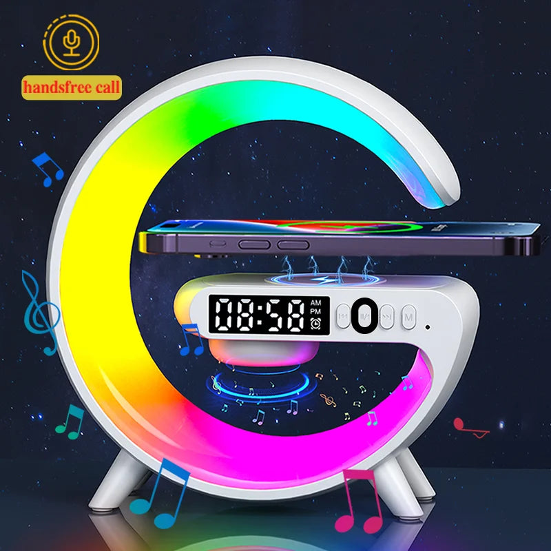 G-shaped white desk speaker with RGB light, digital clock, and wireless phone charging pad.