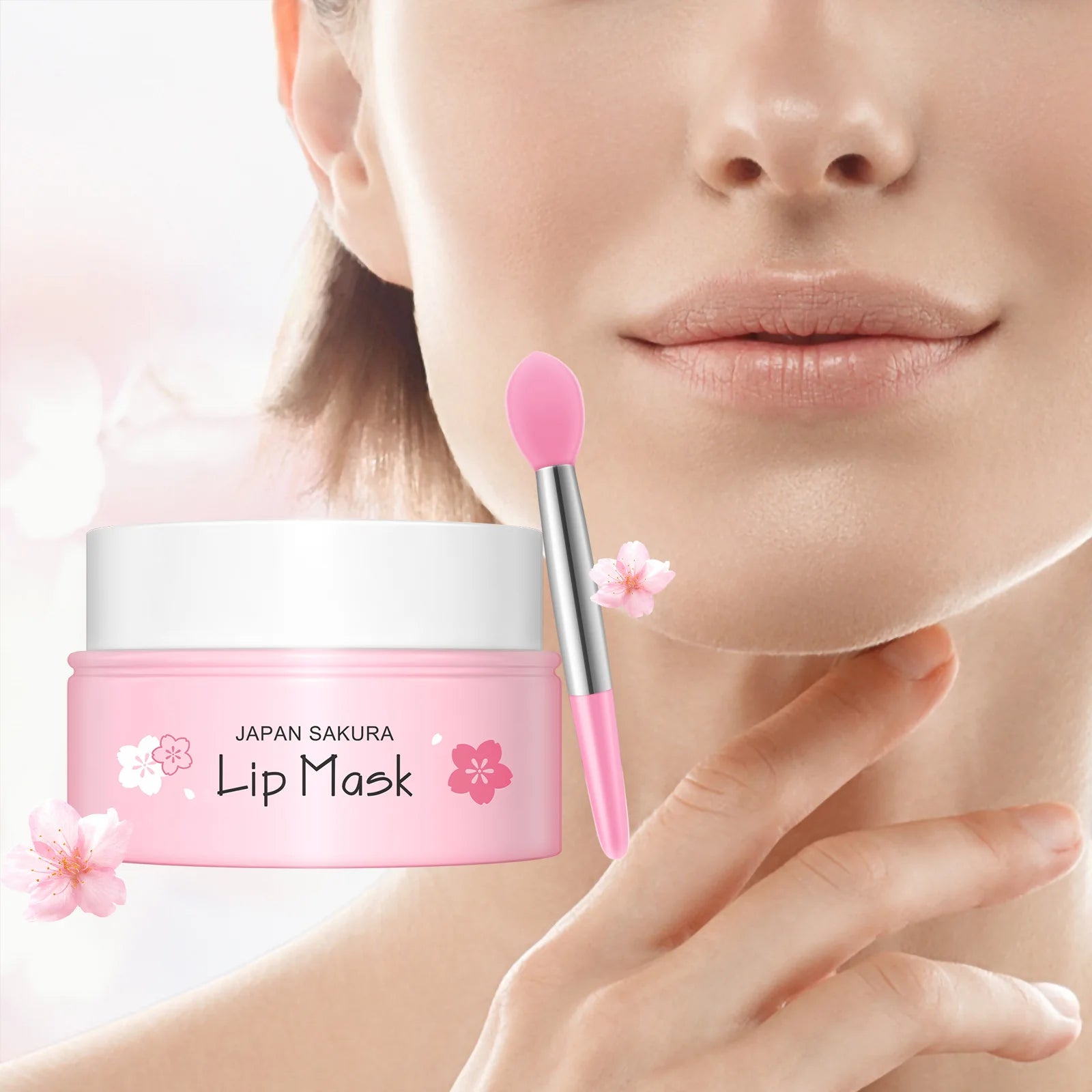Pink Japan Sakura lip mask in a jar with a matching silicone applicator brush, set against a woman's face.