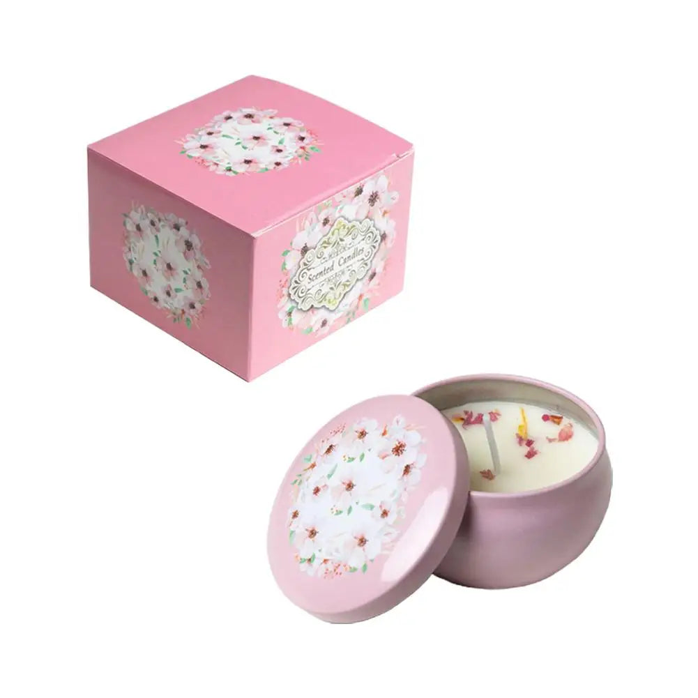 Pink scented candle in a floral tin with a matching gift box, featuring decorative dried flower petals on the wax.