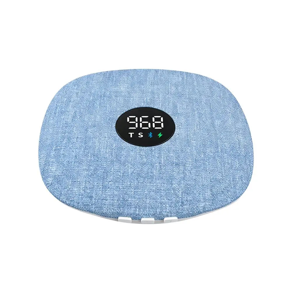 Blue fabric-covered, wireless under-pillow Bluetooth speaker with a central digital display and timer settings.