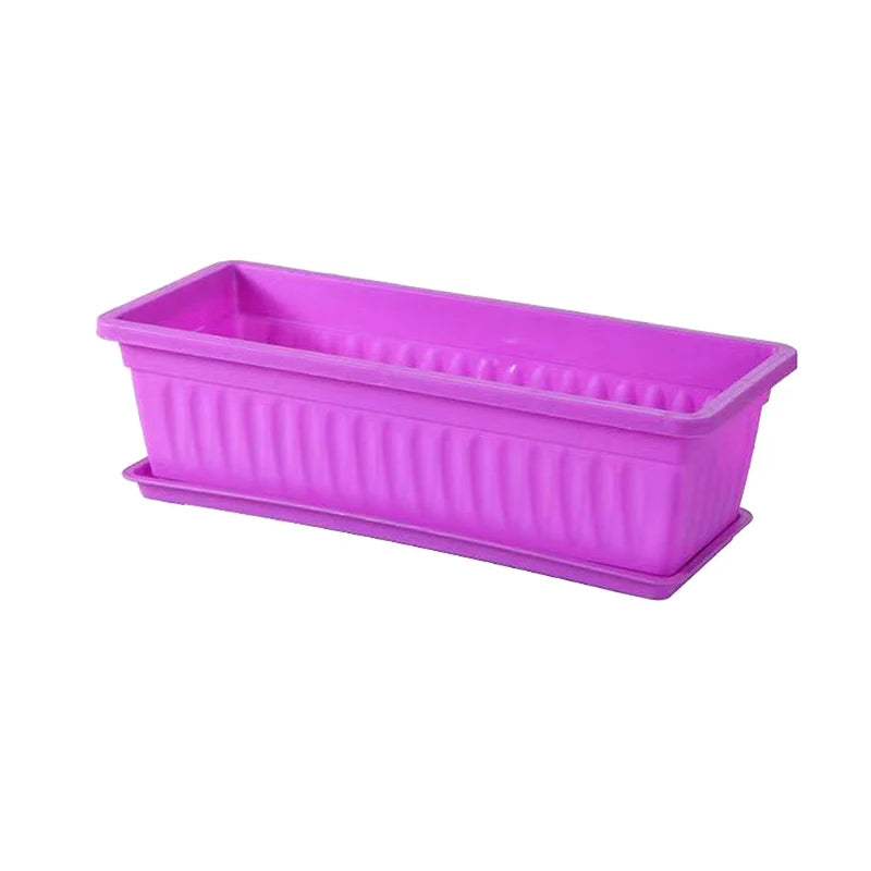 A bright purple, rectangular plastic planter with a matching drip tray, featuring vertical ribbed side detailing.