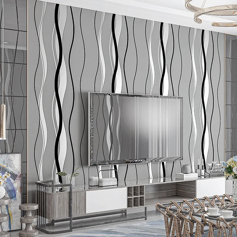 Modern grey wallpaper featuring vertical, wavy black and white stripes, creating a sleek geometric accent wall.