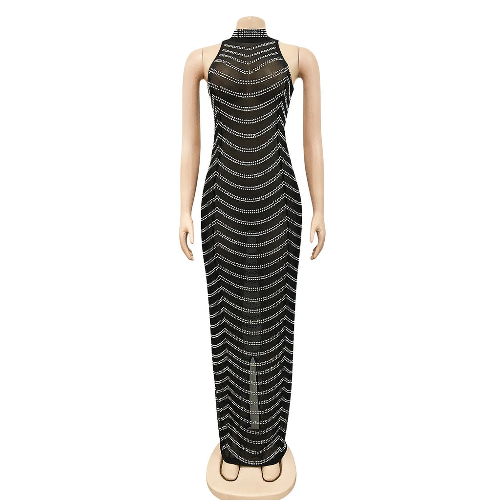 Black maxi dress featuring a high halter neckline, sheer mesh fabric, and cascading rows of gold rhinestone stripes.