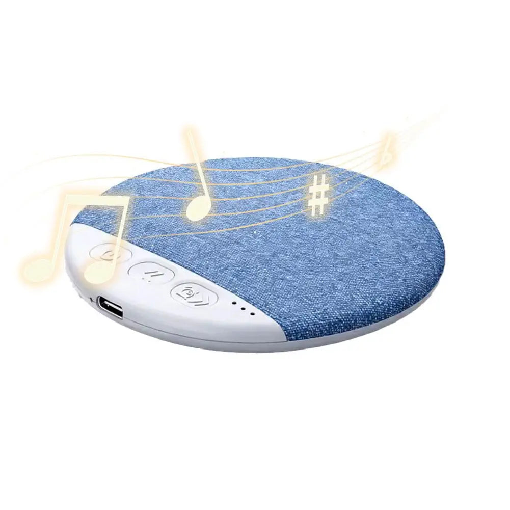 Round blue fabric pillow speaker with white control buttons, charging port and floating musical note graphics.