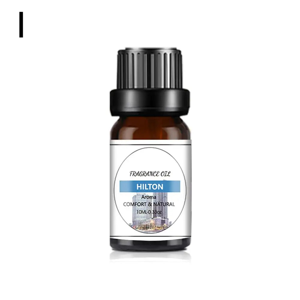 10ml amber glass bottle of fragrance oil with a black cap and white label featuring a city building graphic.